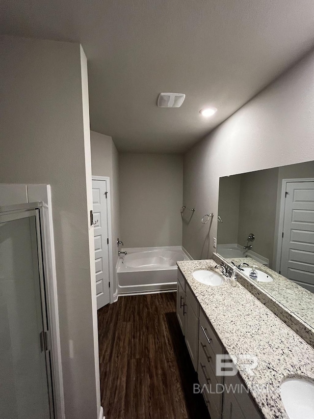 bathroom featuring shower with separate bathtub, vanity, and hardwood / wood-style flooring