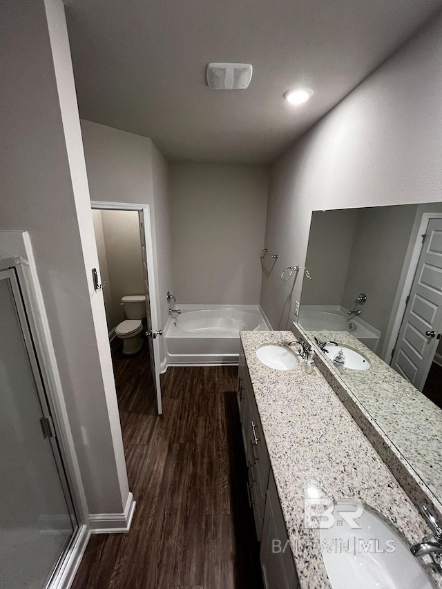 full bathroom featuring toilet, independent shower and bath, vanity, and wood-type flooring