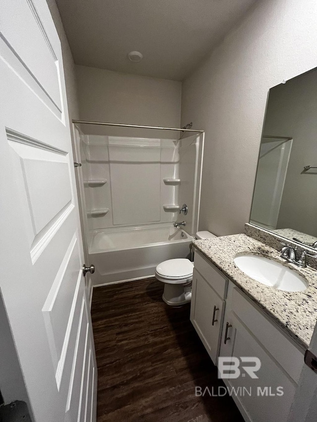 full bathroom with hardwood / wood-style flooring, vanity, toilet, and bathtub / shower combination