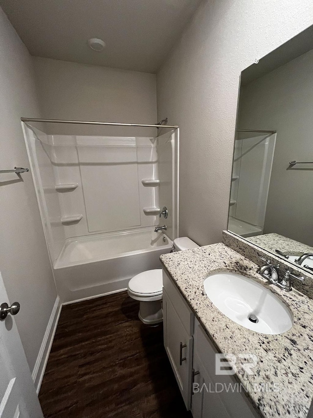 full bathroom featuring hardwood / wood-style flooring, vanity, toilet, and shower / bathtub combination