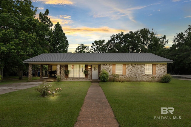 814 Taylor St, Bay Minette, AL 36507 - single story home with a front lawn, concrete driveway, a carport, and a metal roof