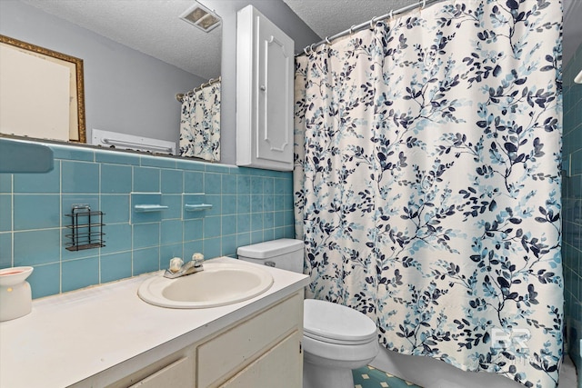 814 Taylor St, Bay Minette, AL 36507 - full bath with a textured ceiling, tile walls, vanity, a shower with curtain, and wainscoting