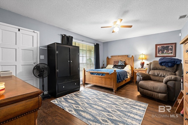 814 Taylor St, Bay Minette, AL 36507 - bedroom with dark wood-style floors, a textured ceiling, and ceiling fan