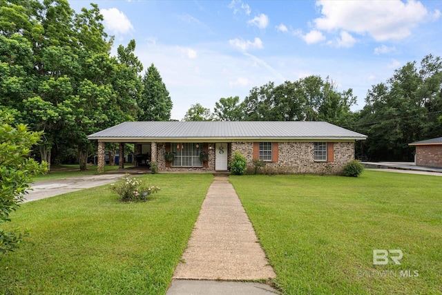 814 Taylor St, Bay Minette, AL 36507 - single story home with driveway, a front lawn, an attached carport, and a metal roof