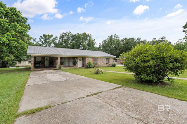 814 Taylor St, Bay Minette, AL 36507 - view of front facade with a front yard, concrete driveway, a metal roof, a carport, and brick siding