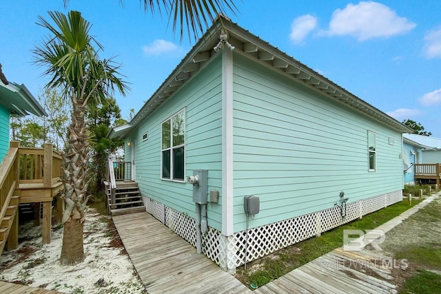 view of side of home with a deck