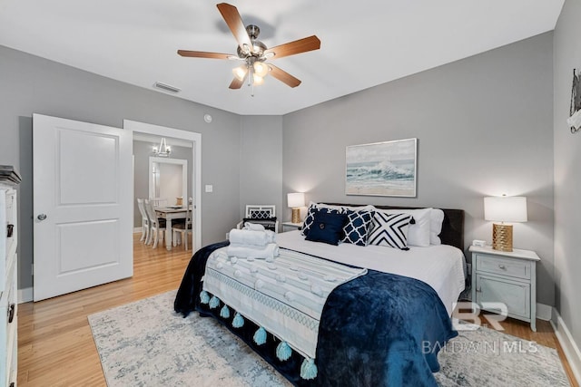 bedroom featuring light hardwood / wood-style floors and ceiling fan