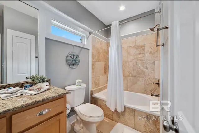 full bathroom with toilet, vanity, and shower / tub combo