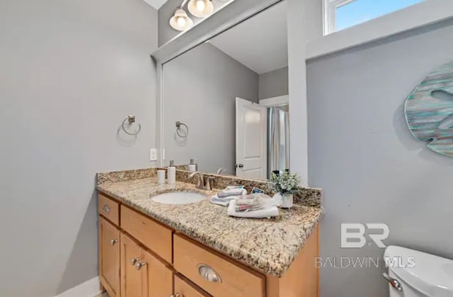 bathroom with vanity and toilet