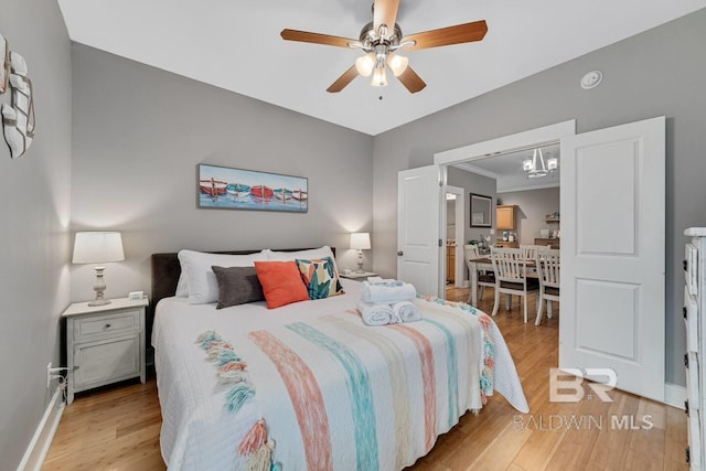 bedroom with light wood-type flooring and ceiling fan