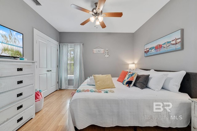 bedroom with light wood-type flooring and ceiling fan