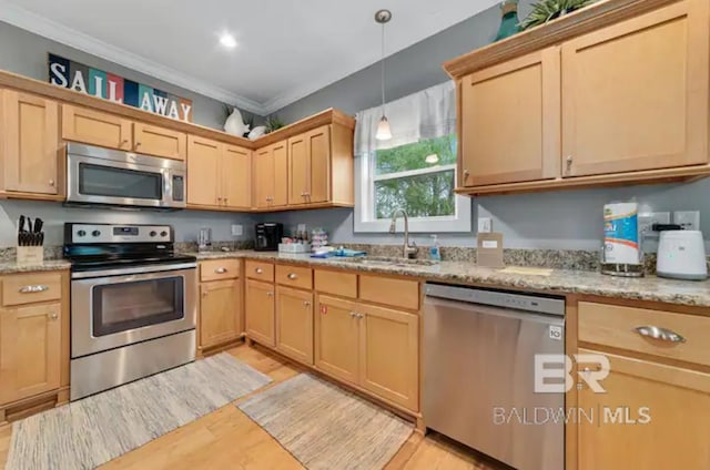 kitchen with light wood-type flooring, ornamental molding, stainless steel appliances, sink, and light stone counters