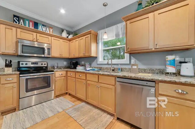 5781 State Highway 180 Unit 5003, Gulf Shores, AL 36542 - kitchen with a sink, light wood finished floors, stainless steel appliances, and light brown cabinetry