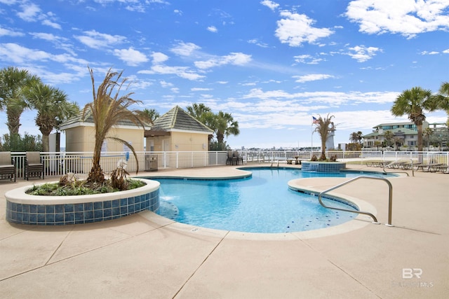 community pool featuring a patio and fence