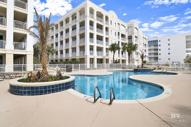 pool featuring a patio area and fence