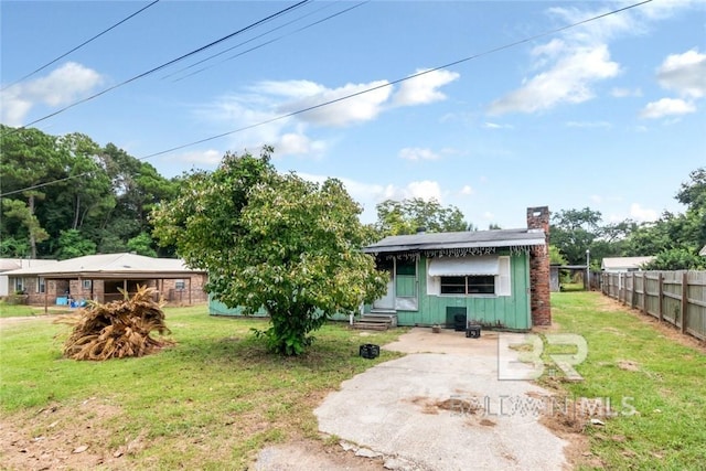 back of property featuring a yard