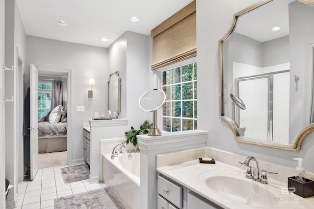 bathroom with shower with separate bathtub, vanity, and tile patterned floors