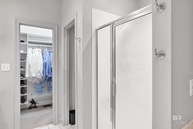 bathroom featuring tile patterned flooring and walk in shower