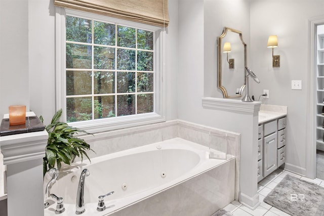 bathroom featuring tiled tub, tile patterned flooring, vanity, and a healthy amount of sunlight