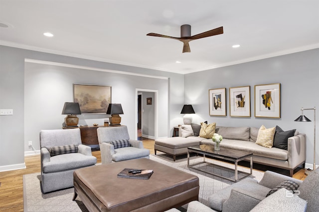 living room featuring light hardwood / wood-style flooring, ceiling fan, and crown molding