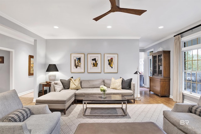 living room with ceiling fan, ornamental molding, and light hardwood / wood-style flooring