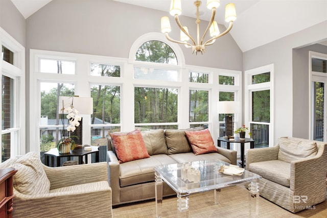 sunroom / solarium with lofted ceiling, a wealth of natural light, and an inviting chandelier