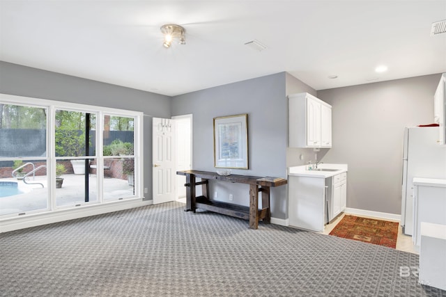 laundry area featuring carpet floors and sink