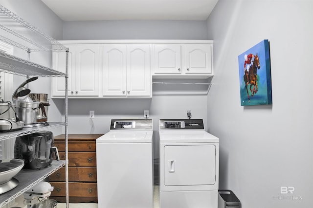 washroom featuring cabinets and independent washer and dryer