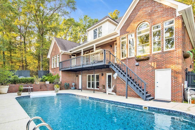 rear view of property with a fenced in pool