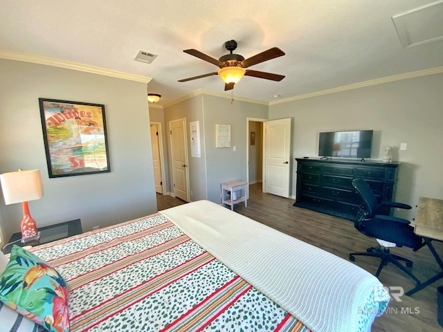 bedroom with crown molding, dark wood finished floors, visible vents, attic access, and a ceiling fan