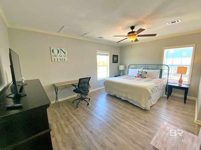 bedroom with light wood-type flooring, visible vents, and crown molding