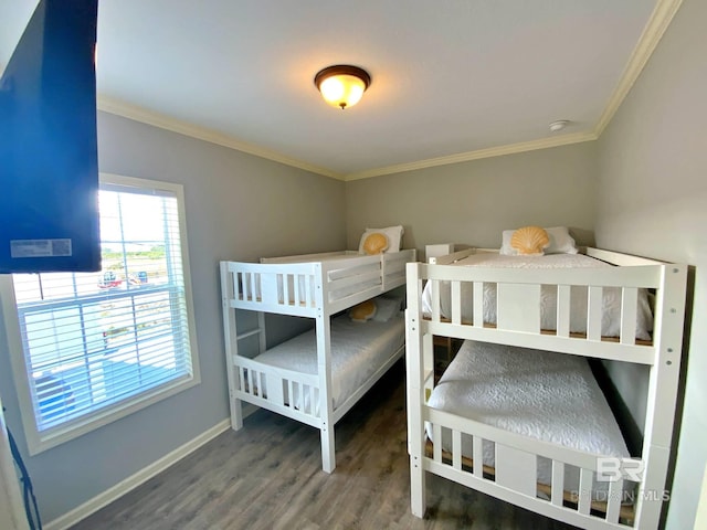 bedroom with baseboards, ornamental molding, and wood finished floors