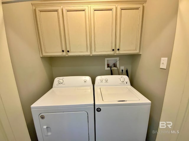 laundry area with washing machine and dryer and cabinet space