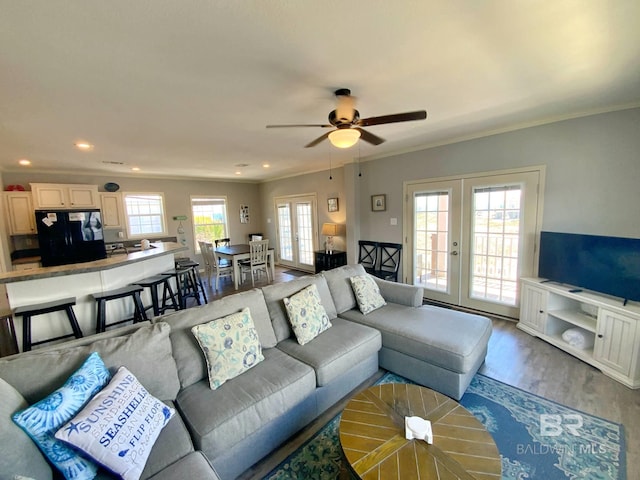 living area featuring ornamental molding, wood finished floors, and french doors