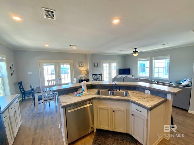 kitchen featuring french doors, visible vents, open floor plan, a kitchen island with sink, and dishwasher