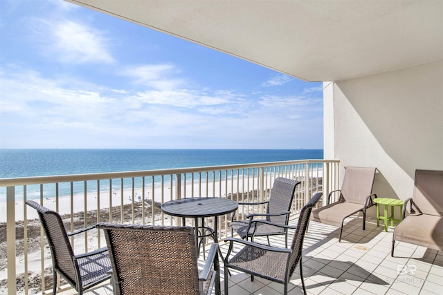 balcony with a water view and a beach view