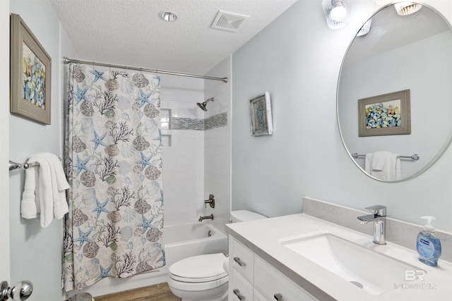 bathroom with vanity, visible vents, a textured ceiling, toilet, and shower / bath combo with shower curtain