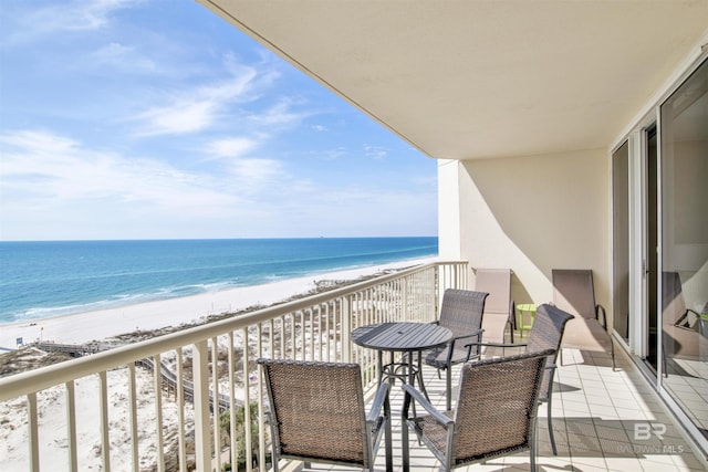 balcony featuring a beach view and a water view