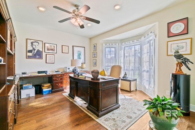 office space featuring wood-type flooring and ceiling fan