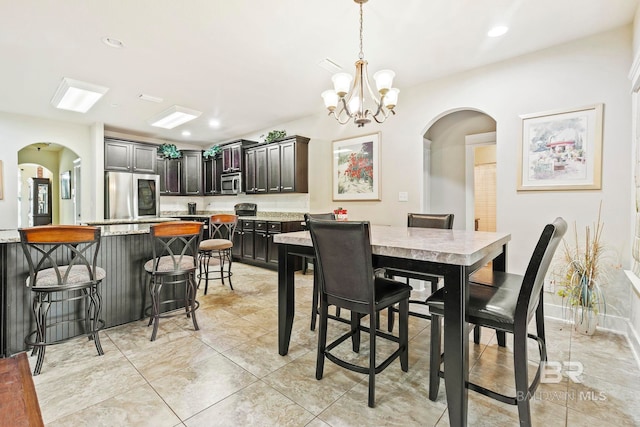 dining area with an inviting chandelier