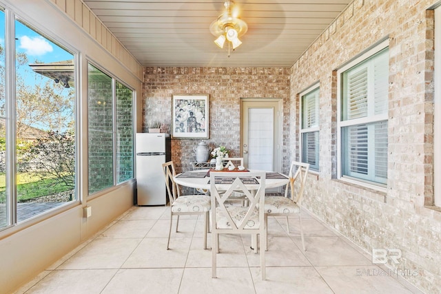 sunroom with ceiling fan and wood ceiling