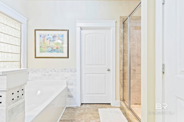 bathroom featuring tile patterned floors and independent shower and bath