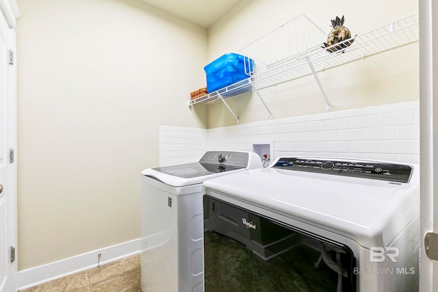 washroom featuring washer and dryer and tile patterned flooring