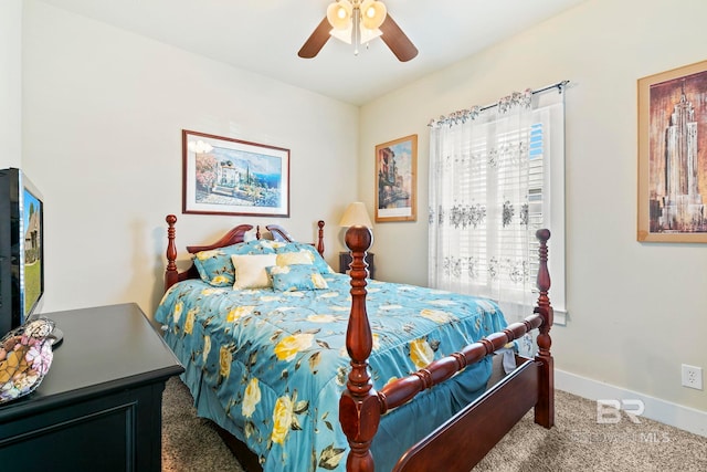 bedroom with ceiling fan and dark colored carpet