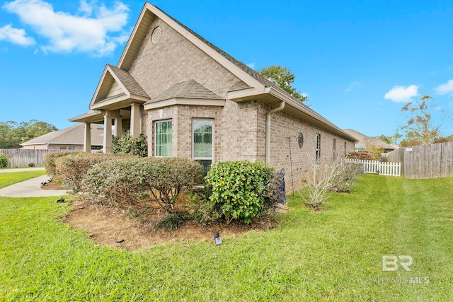 view of side of home featuring a lawn