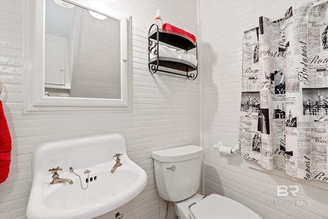half bathroom featuring toilet