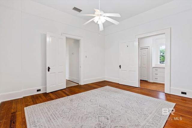 unfurnished bedroom with baseboards, visible vents, a ceiling fan, and wood finished floors
