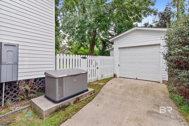 garage with driveway and fence