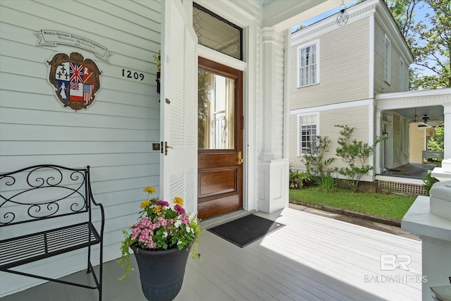 view of exterior entry featuring covered porch