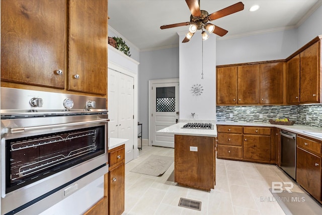 kitchen with stainless steel appliances, ornamental molding, ceiling fan, light countertops, and light tile patterned floors